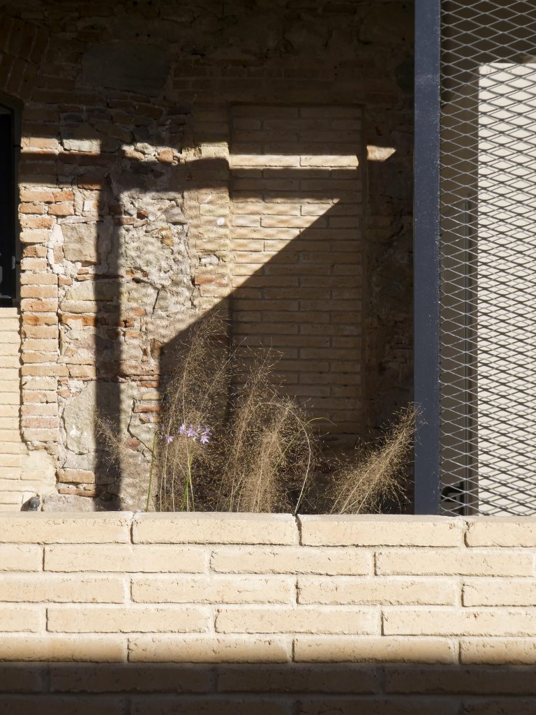 sunny shadows cast over an patio architecture brick and old stones