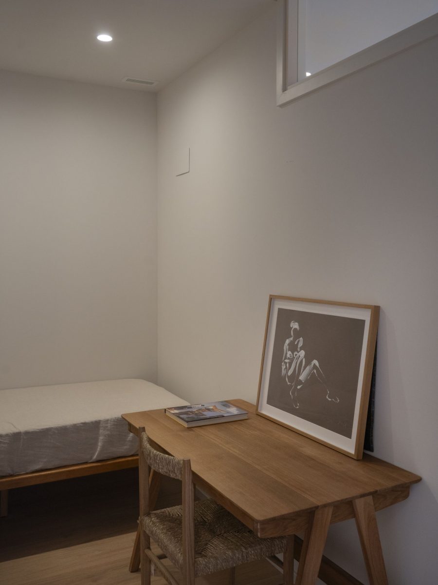 small room architecture with small desk and single bed poster of a painting standing on desk